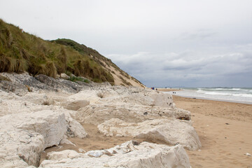Fototapeta na wymiar Limestone Rocks on the beach and shoreline near Port Ballintrae ion the causeway coas