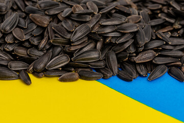Ukraine flag and sunflower seeds. Sunflower oil exports, production and supply concept.