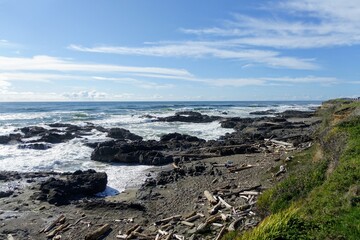 A view of the rugged Oregon coast with waves crashing against the shore in the beautiful coastal town of Yachats, Oregon