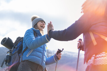 Give me five. Joyful satisfied funny hikers holding hands up smiling and gesticulating - Discovery Travel Destination Concept.