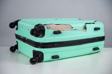Mint damaged suitcase on a white background.