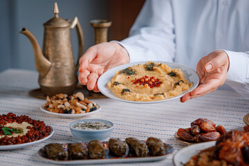 Hummus close-up, middle eastern national traditional food. Muslim family dinner, Ramadan, iftar....