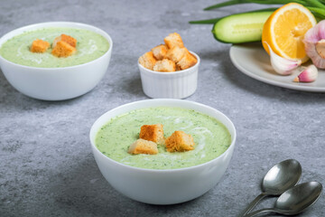 Vegan cream cold soup with cucumber, yogurt, garlic, herbs, lemon and croutons. Diet food concept. Vegetarian and vegan food