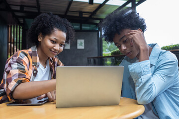 Student Life. Two students in school and working on laptop, checking social media. Teen student in...