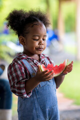 child eating fresh watermelon. Child Little Girl  holding watermelon. Cute young little girl eating...