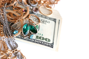 Many expensive golden and silver jewerly rings, earrings and necklaces with big amount of US dollar...