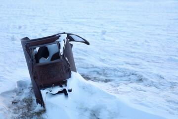 old rusty in the wild ofen in svalbard / spitzbergen with snow and ice