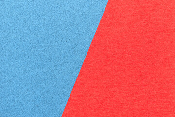 Fototapeta premium Texture of craft red and blue paper background, half two colors, macro. Structure of vintage dense craft cardboard