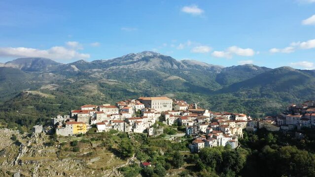 The imposing medieval village of Aieta on its mountain in the green countryside in Europe, Italy, Calabria, in summer on a sunny day.
