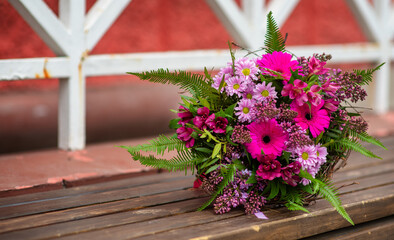 Wedding bouquet on a wooden bench