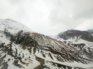 View of beautiful snowy mountains and a cloud covering the landscape and dam