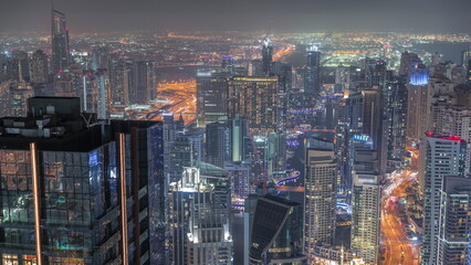 Skyline view of Dubai Marina showing canal surrounded by skyscrapers along shoreline night timelapse. DUBAI, UAE