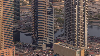 Jumeirah Lakes Towers district with many skyscrapers along Sheikh Zayed Road aerial timelapse.