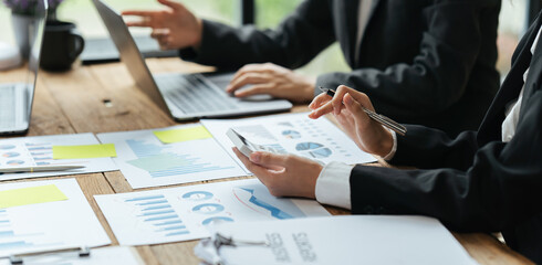 Teamwork with business people analysis cost graph on desk at meeting room, business team briefing plan. creative startup business people group in office.