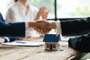 Real estate broker and customer shaking hands after signing a contract: real estate, home loan and insurance concept - obrazy, fototapety, plakaty