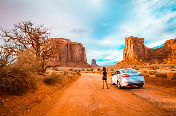 A female tourist driving through the interior of Monument Valley, Utah, United States