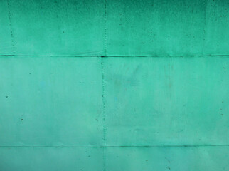 beautiful background of old solid metal garage wall painted with green paint