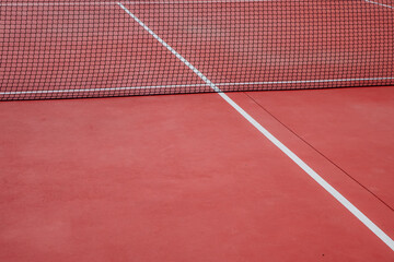 Red hard-surface tennis court, racket sports concept