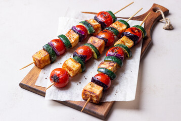 Grilled skewers with halloumi cheese, zucchini, tomatoes and onions. Kebab. Healthy eating. Vegetarian food.