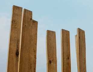 Wooden construction boards on the background of the sky selective focus. Building materials in the form of wooden boards prepared for use.