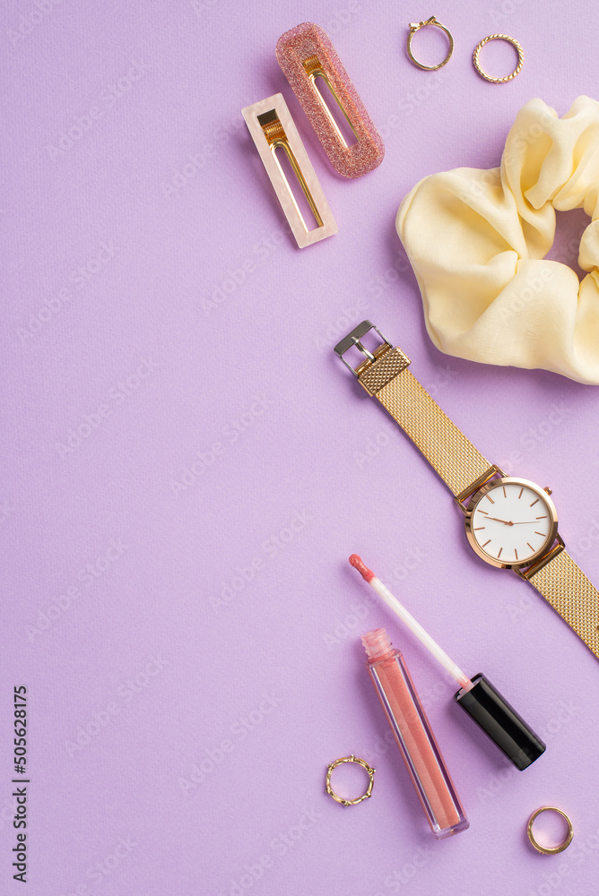 Wall mural makeup beauty concept. top view vertical photo of scrunchy lip gloss gold wrist watch rings and barr