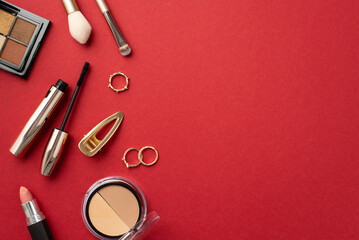 Make-up beauty concept. Top view photo of lipstick contouring eyeshadow palettes mascara makeup brushes gold rings and hairpin on isolated red background with copyspace