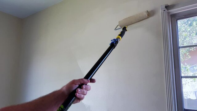 Home Decor, Applying White Paint to a Wall with a Paint Roller on Pole, Beside Window