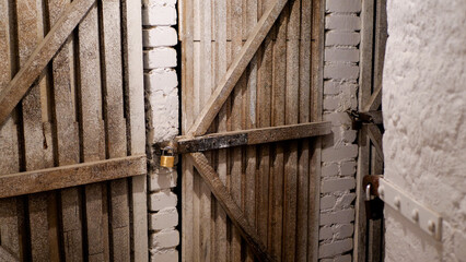 Locked wooden door in the basement - 505631152