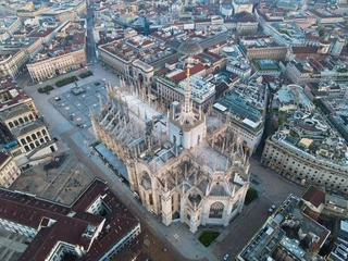 Wall murals Milan Aerial view of Duomo di Milano Cathedral in Duomo Square. Gothic cathedral in the center of Milan. Drone view of the gallery and Milano rooftops, in north Italy, Lombardia. Birds eye of Duomo facade.