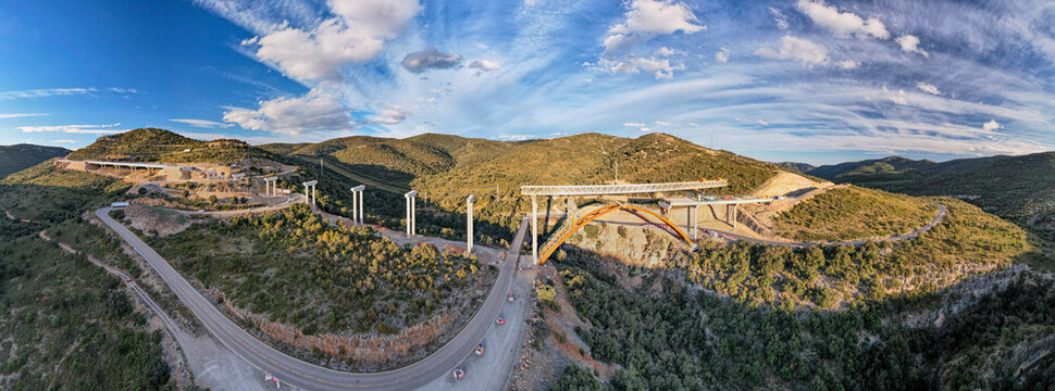 Amazing panoramic view of a new bridge construction with dramatic blue sky and clouds in the background in Morella