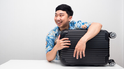 Man blue shirt with luggage smling and looking at copy space thinking to holiday trip