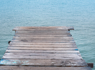  Fisherman's wooden log terrace leading into the sea. - 505635543