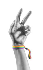 Raised black and white arm wearing a bracelet with the colors of the LGBT flag. LGBT symbol.