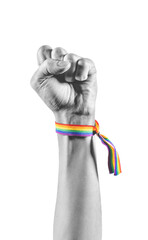 Black and white arm wearing a bracelet with the colors of the LGBT flag closing the fist as a...
