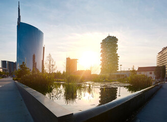 Modern buildings and artificial lake and gardens of the new business district of Milan.