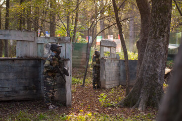 children playing paintball in the forest