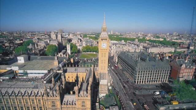 Ariel view of Parliament, Westminster, London. Morning sunlight, some traffic, Big Ben and Thames river.