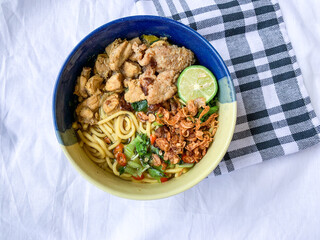 Noodle chicken soup (mie ayam) Indonesia food served on bowl.