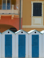 white wooden dressing room with blue doors on the beach near Genoa.Paradise gulf, Italy