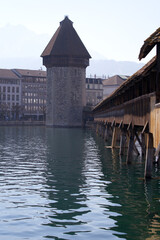 Waterfront with famous water tower and covered wooden Chapel Bridge with Reuss River in the...