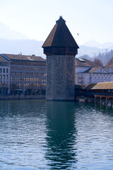 Waterfront with famous water tower and covered wooden Chapel Bridge with Reuss River in the...