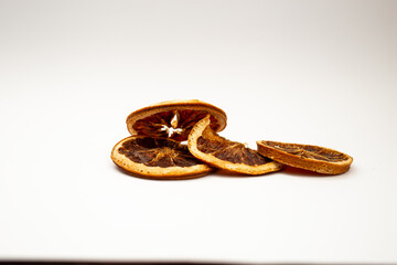 Dried fruit, fruit and cinnamon on white background