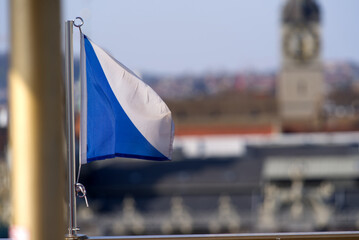 Aerial view over City of Zürich from ferris wheel with flag of City and Canton Zürich in the foreground and defocus background. Photo taken March 28th, 2022, Zurich, Switzerland.