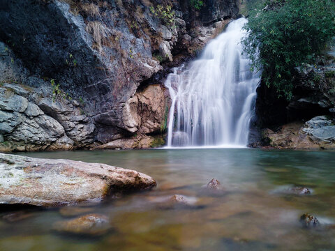 A beautiful waterfall with green pond in the middle of the forest in the outskirts of dehradun city of Uttarakhand , India.