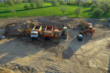 Excavator and Soil compactor on road work. Earth-moving heavy equipment and Construction machinery...