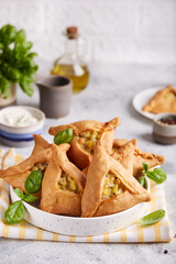 Pies with chicken, potato, onion and herbs.  Small homemade kurnik meat pies in a shape of triangle. Healthy dinner for the family.  © natkinzu
