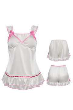 Close-up pyjama set of a white frill vest and frill shorts with a pink contrast piping trim. The nightwear is isolated on a white background. Front and back view of shorts.