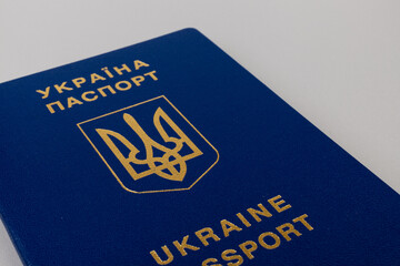 Ukrainian passport with a golden trident symbol on light background. Biometric Ukraine passport id empty place for photo or text.