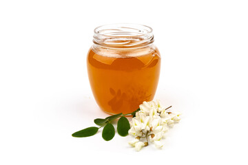 Jar of honey with flowers of acacia isolated on white background
