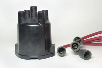 ignition distributor cap front side. set of high tension cables, rubber boots on terminals